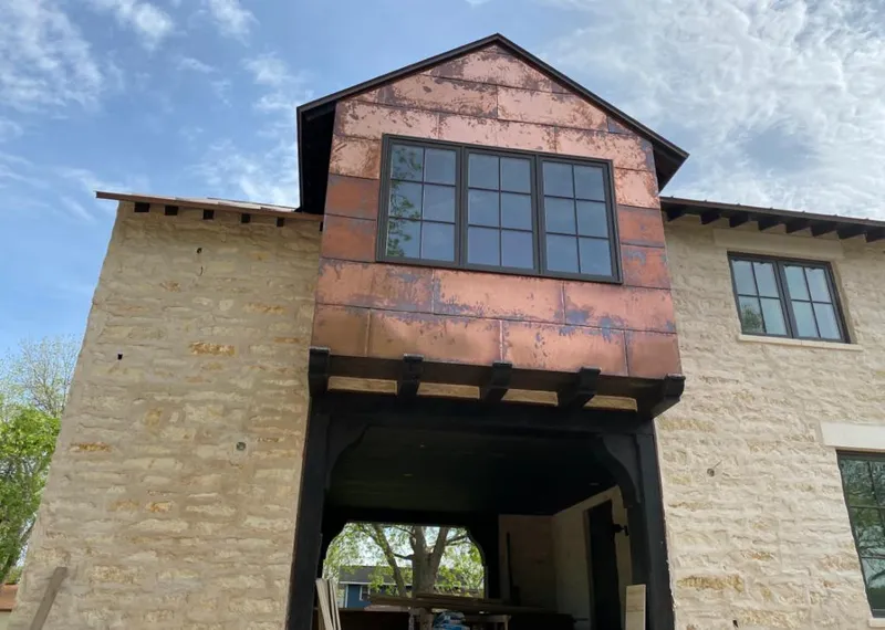 Copper metal panel facade on a stone building for Skylight Installation in Laurel Hill