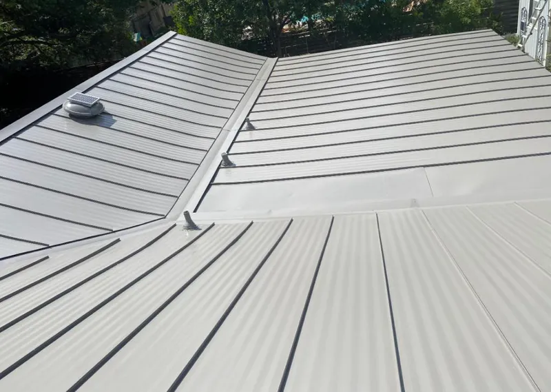 Solar attic fan installed on a metal roof for Roof Ventilation in Laurel Hill